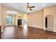 Spacious living room with hardwood floors and arched doorways and large windows for natural light at 13132 Coldwater Loop, Clermont, FL 34711