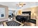 Large main bedroom with wood flooring, a sitting area, and an en-suite bathroom at 13132 Coldwater Loop, Clermont, FL 34711