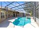 Beautiful in-ground pool and spa is enclosed with a screened cage and surrounded by a large patio at 13132 Coldwater Loop, Clermont, FL 34711