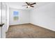 Spacious bedroom with brown carpet, ceiling fan, and window at 13656 Crystal River Dr, Orlando, FL 32828