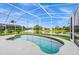 Refreshing kidney-shaped pool with screened enclosure and lake view at 13656 Crystal River Dr, Orlando, FL 32828