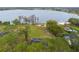 Aerial view of a vacant lakefront lot surrounded by trees and homes at 14415 Lake Huckleberry Ln, Winter Garden, FL 34787