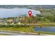 Aerial view showing this waterfront property and its lake access, plus nearby homes and community amenities at 14415 Lake Huckleberry Ln, Winter Garden, FL 34787