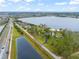 Aerial view of lakefront property with a large lot and neighboring houses at 14415 Lake Huckleberry Ln, Winter Garden, FL 34787