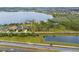 This aerial shot shows lakefront houses with sprawling lawns along the water's edge, near a peaceful waterway at 14415 Lake Huckleberry Ln, Winter Garden, FL 34787