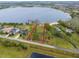 This is an aerial view of an undeveloped lot on a lakefront property, with lush greenery and ample space at 14415 Lake Huckleberry Ln, Winter Garden, FL 34787