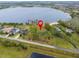 Aerial view of waterfront property with surrounding homes and lake at 14415 Lake Huckleberry Ln, Winter Garden, FL 34787