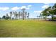 Spacious backyard with lake view and green grass at 14415 Lake Huckleberry Ln, Winter Garden, FL 34787