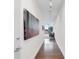 Bright hallway with hardwood floors and modern art at 150 E Robinson St # 1410, Orlando, FL 32801