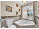 Relaxing bathroom with corner bathtub and large window overlooking nature at 174 Northshore Cir, Casselberry, FL 32707