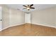 Spacious bedroom with wood flooring, ceiling fan, and access to another room at 174 Northshore Cir, Casselberry, FL 32707