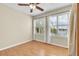 Bright bedroom with wood floors, plantation shutters, and water views at 174 Northshore Cir, Casselberry, FL 32707