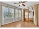 Well-lit bedroom with wood flooring, ceiling fan, and access to loft at 174 Northshore Cir, Casselberry, FL 32707