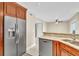 Stainless steel appliances and wood cabinets highlight this kitchen at 174 Northshore Cir, Casselberry, FL 32707