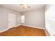 A well-lit bedroom featuring wood-look flooring, a ceiling fan, and ample natural light at 2302 Midtown Ter # 1228, Orlando, FL 32839