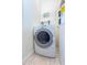 Clean laundry area with a white washer and dryer, and shelving for storage at 2302 Midtown Ter # 1228, Orlando, FL 32839