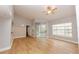 Bright living room with wood floors, neutral walls, ceiling fan and sliding door to balcony at 2302 Midtown Ter # 1228, Orlando, FL 32839