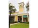 City Street Market, a yellow apartment commercial building with clock tower, offering market amenities to the community at 2302 Midtown Ter # 1228, Orlando, FL 32839