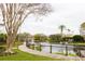 Scenic pond featuring a gazebo and boardwalk, complemented by colorful apartment buildings and lush landscaping at 2302 Midtown Ter # 1228, Orlando, FL 32839