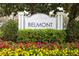 Community signage for Park Central Belmont amid colorful flowerbed, and lush greenery at 2302 Midtown Ter # 1228, Orlando, FL 32839