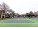 Apartment tennis court with green surface offers a recreational amenity for residents and adds an element of active living at 2302 Midtown Ter # 1228, Orlando, FL 32839