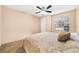 Bright bedroom with ceiling fan, carpeted floor, and a queen-size bed at 236 Afton Sq # 103, Altamonte Springs, FL 32714