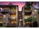 Two-story condo building with balconies and a staircase at dusk at 236 Afton Sq # 103, Altamonte Springs, FL 32714