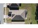 Aerial view of a house with a dark brown roof and screened enclosure at 2408 Addison Creek Dr, Kissimmee, FL 34758