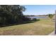 View of a pond and lush landscaping from the backyard at 2408 Addison Creek Dr, Kissimmee, FL 34758