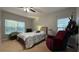 Spacious bedroom with a comfortable bed, recliner, and ample natural light at 2408 Addison Creek Dr, Kissimmee, FL 34758