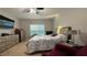 Bright bedroom featuring a bed, dresser, and large window at 2408 Addison Creek Dr, Kissimmee, FL 34758