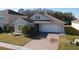 Single-story home with a light beige exterior and a two-car garage at 2408 Addison Creek Dr, Kissimmee, FL 34758