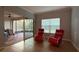 Relaxing living area with red rocking chairs and access to lanai at 2408 Addison Creek Dr, Kissimmee, FL 34758