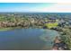 Aerial view of house near a lake in a suburban area at 2530 Domenico Paul Way, Orlando, FL 32810