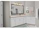 Elegant bathroom with granite vanity and large mirror at 2530 Domenico Paul Way, Orlando, FL 32810