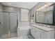 Neutral bathroom featuring tiled shower, soaking tub, granite counters, and white cabinets at 2530 Domenico Paul Way, Orlando, FL 32810