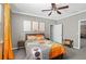 Stylish bedroom with modern decor, ceiling fan, and door leading to another room at 2530 Domenico Paul Way, Orlando, FL 32810