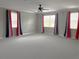 Spacious bonus room with carpet flooring and large windows that provide ample natural light at 2530 Domenico Paul Way, Orlando, FL 32810