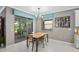 Cozy dining area with backyard access, chandelier, and neutral color palette at 2530 Domenico Paul Way, Orlando, FL 32810
