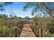 Scenic dock overlooking a calm lake surrounded by lush greenery and blue sky at 2530 Domenico Paul Way, Orlando, FL 32810