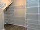 Empty closet showcases wire shelving, wood-look floor, and potential for organization at 2530 Domenico Paul Way, Orlando, FL 32810