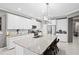 Bright kitchen features a large center island with granite counters, stainless appliances, and white cabinetry at 2530 Domenico Paul Way, Orlando, FL 32810