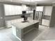 Spacious kitchen features white cabinets, granite countertops, stainless steel appliances, and a large island at 2530 Domenico Paul Way, Orlando, FL 32810
