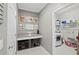 Functional laundry room with storage, folding counter, and tile flooring at 2530 Domenico Paul Way, Orlando, FL 32810