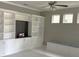 Bright living room with built-in shelving, cabinets, display niche, and window bench seating at 2530 Domenico Paul Way, Orlando, FL 32810