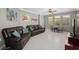 Spacious living room with tile floors, modern furniture, a ceiling fan, and natural light at 2530 Domenico Paul Way, Orlando, FL 32810