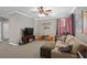 Inviting living room featuring a large TV, comfortable seating, and neutral colors at 2530 Domenico Paul Way, Orlando, FL 32810