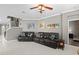 Cozy living room with tile floors, crown molding, leather furniture, and stairway access at 2530 Domenico Paul Way, Orlando, FL 32810