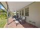 Covered patio featuring brick flooring, comfortable seating, and outdoor ceiling fan at 2530 Domenico Paul Way, Orlando, FL 32810