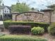 Retreat at Lake Bosse entrance featuring stone sign and colorful landscaping at 2530 Domenico Paul Way, Orlando, FL 32810